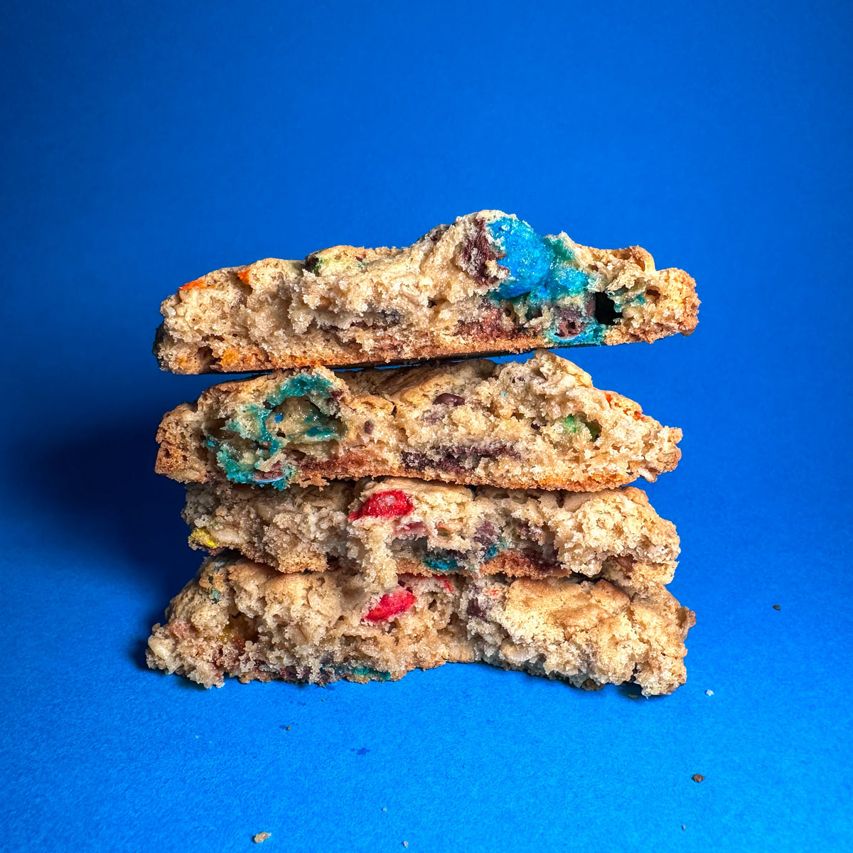Mega Monster cookies stacked and torn in half, showing the inside